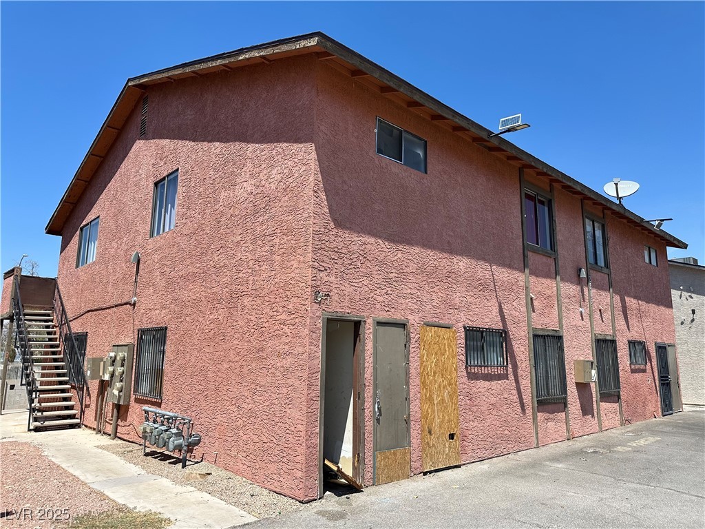 2305 Exeter Drive Las Vegas, NV 89156 - Photo 4 of 6 View of side of home featuring stairs and stucco siding