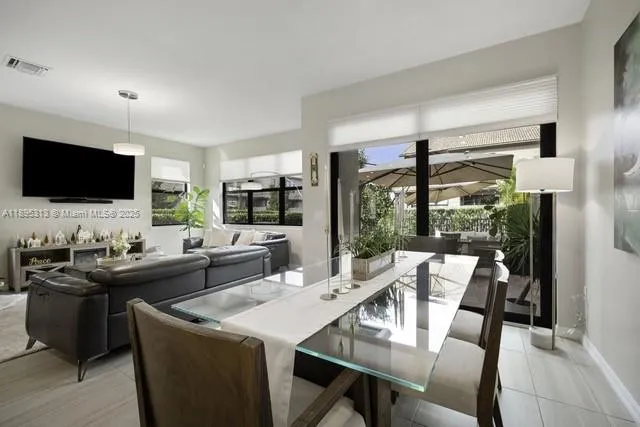 a living room with furniture a flat screen tv and a large window