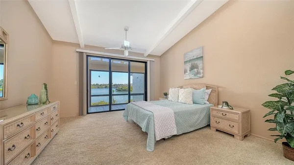 a bedroom with a large bed and a window