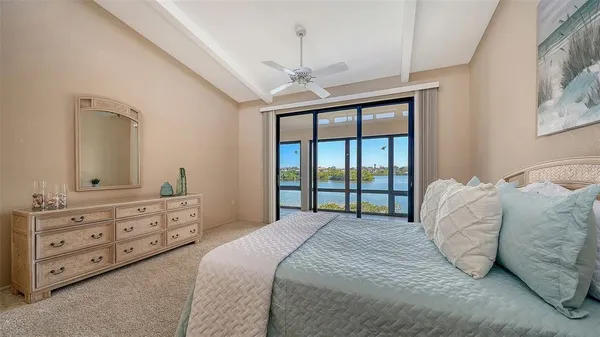 a bedroom with a bed and a painting on the wall