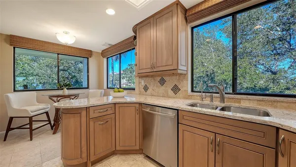a kitchen with a sink and large window