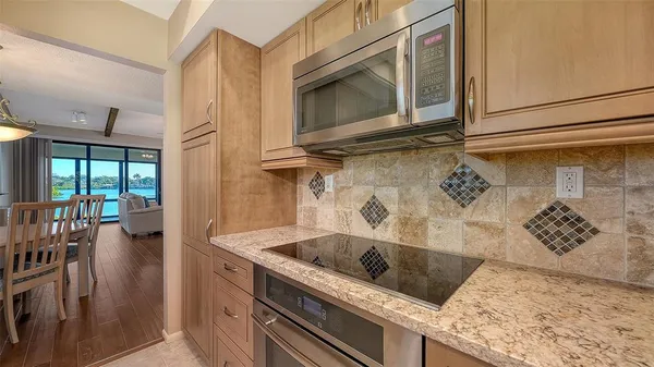 a kitchen with granite countertop a sink and a microwave