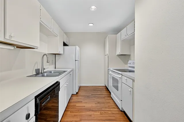 a kitchen with stainless steel appliances a sink stove top oven and cabinets