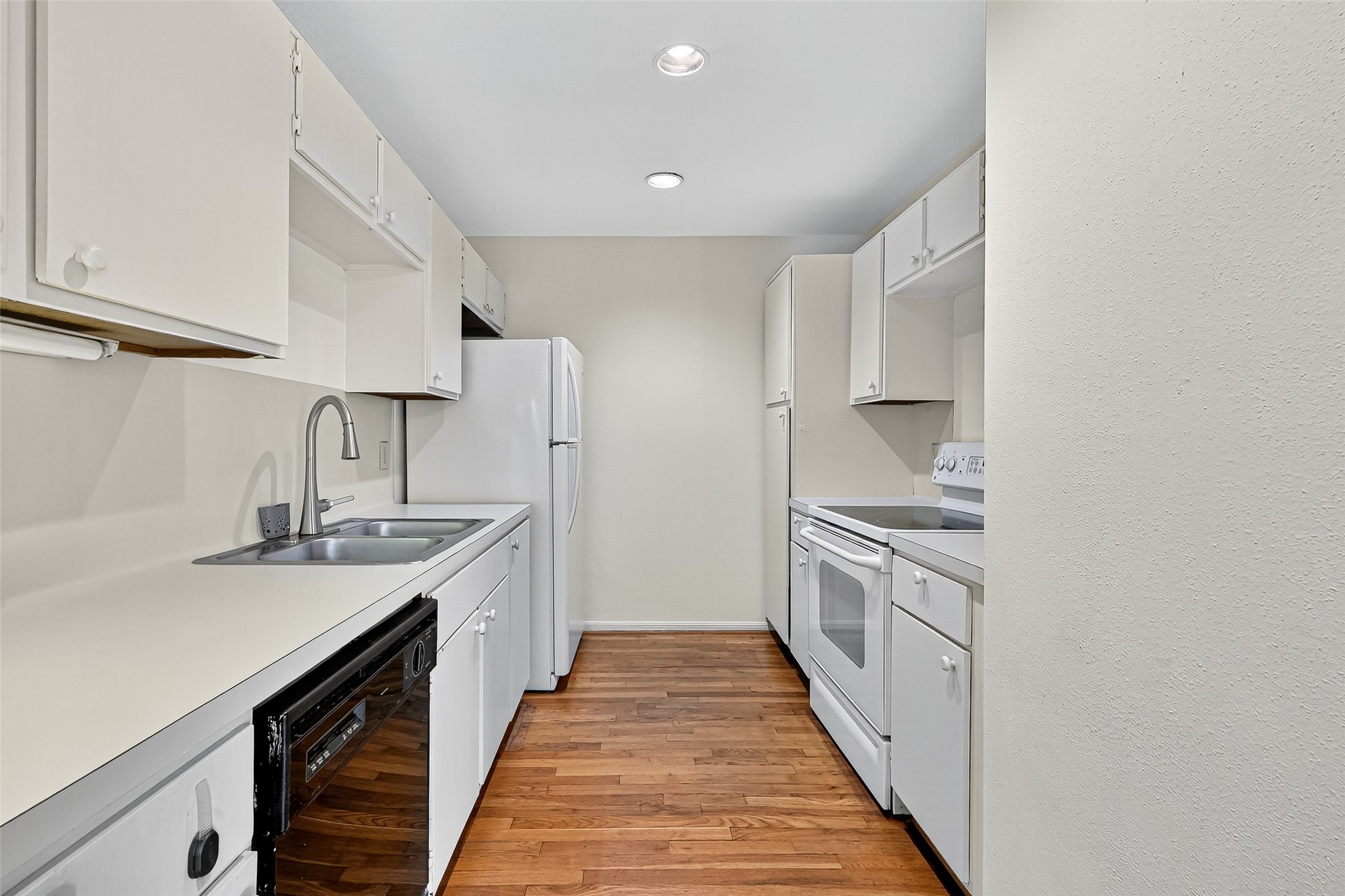 2829 Timmons Lane, Unit 176 Houston, TX 77027 - Photo 12 of 34 a kitchen with stainless steel appliances a sink stove top oven and cabinets