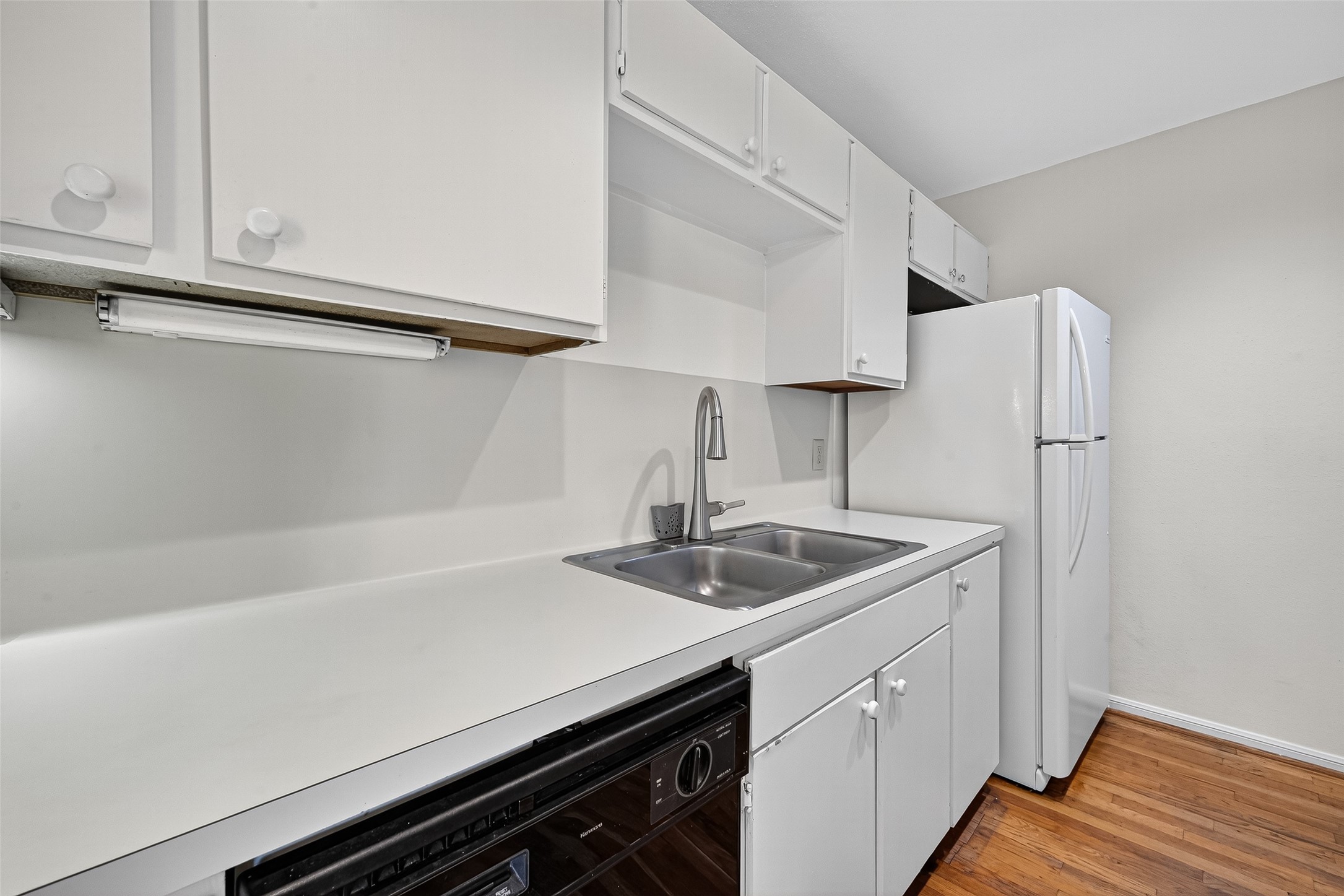 2829 Timmons Lane, Unit 176 Houston, TX 77027 - Photo 13 of 34 a kitchen with stainless steel appliances a sink dishwasher and cabinets