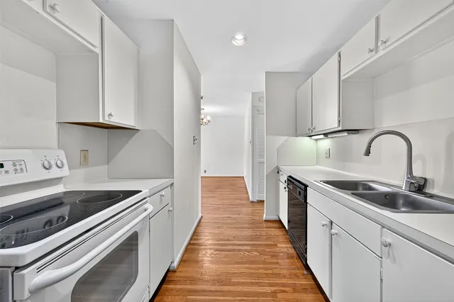 a kitchen with stainless steel appliances granite countertop a sink and a stove
