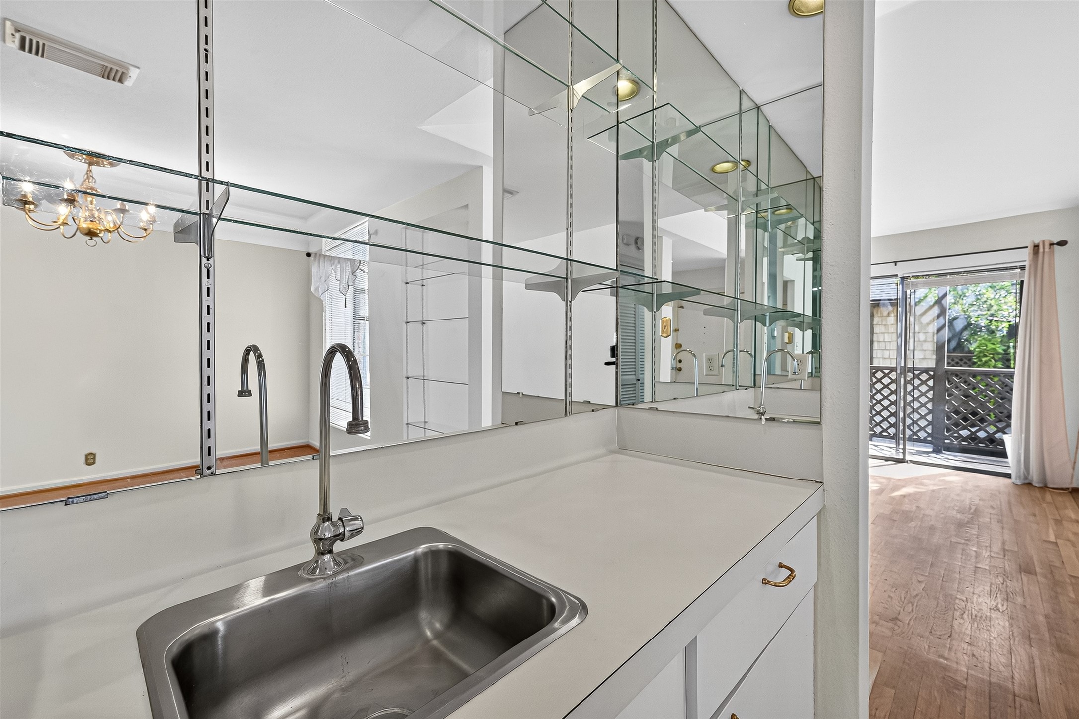 2829 Timmons Lane, Unit 176 Houston, TX 77027 - Photo 19 of 34 a kitchen with a sink and a wooden floor