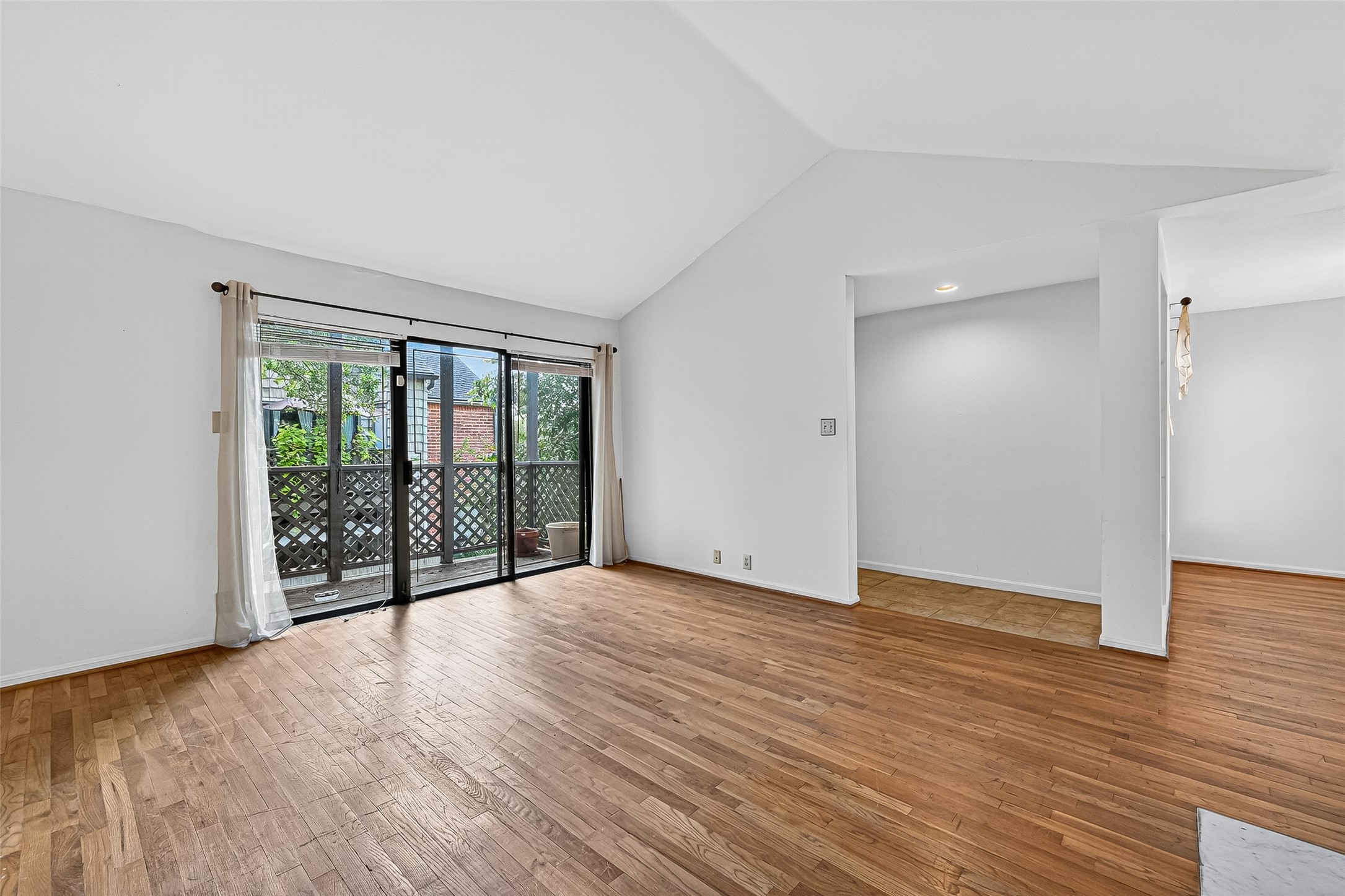 2829 Timmons Lane, Unit 176 Houston, TX 77027 - Photo 7 of 34 a view of an empty room with wooden floor and a window