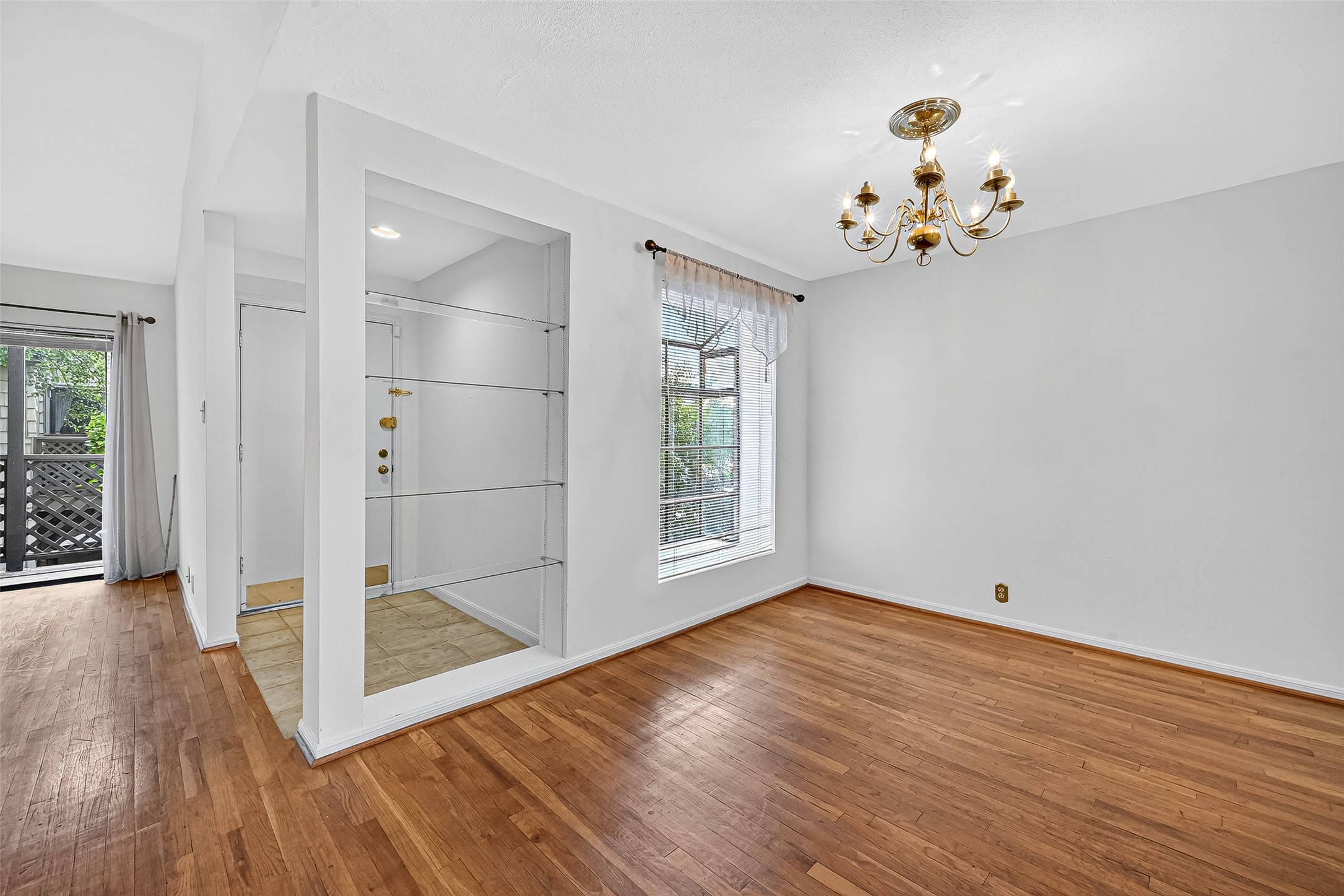 2829 Timmons Lane, Unit 176 Houston, TX 77027 - Photo 9 of 34 a view of an empty room with wooden floor and a window