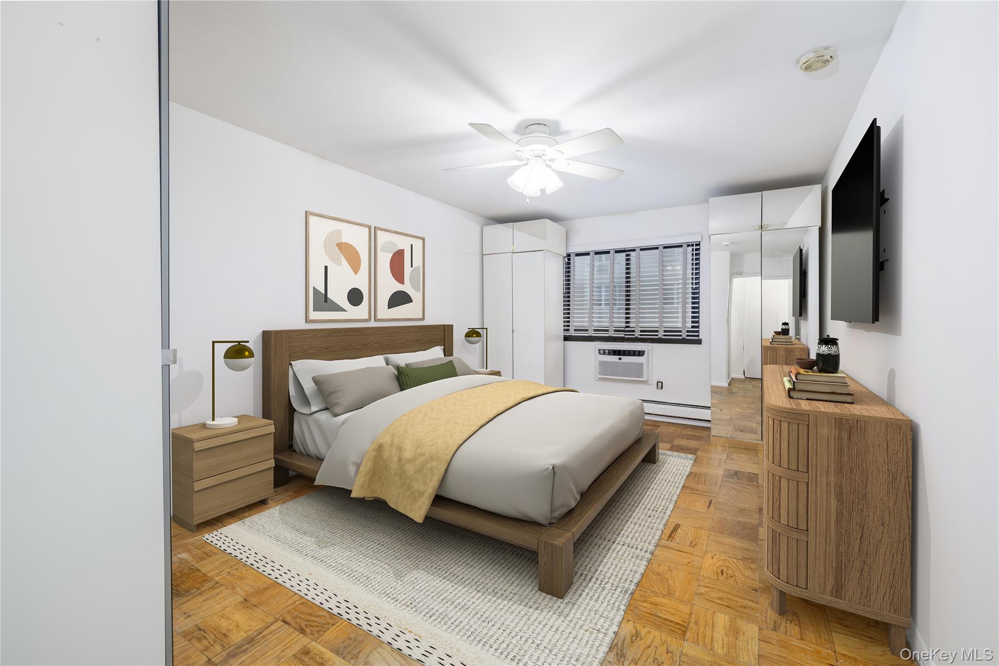 420 Shore Road, Unit 1F Long Beach, NY 11561 - Photo 20 of 32 a bedroom with a large bed a flat tv screen and dresser