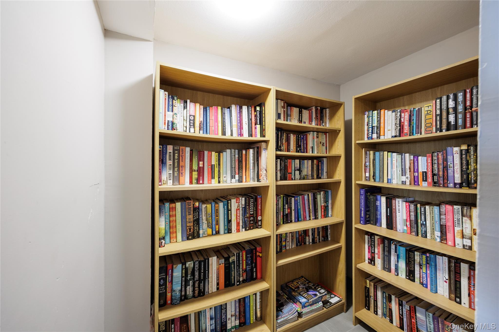 420 Shore Road, Unit 1F Long Beach, NY 11561 - Photo 29 of 32 a living room with furniture and a book shelf