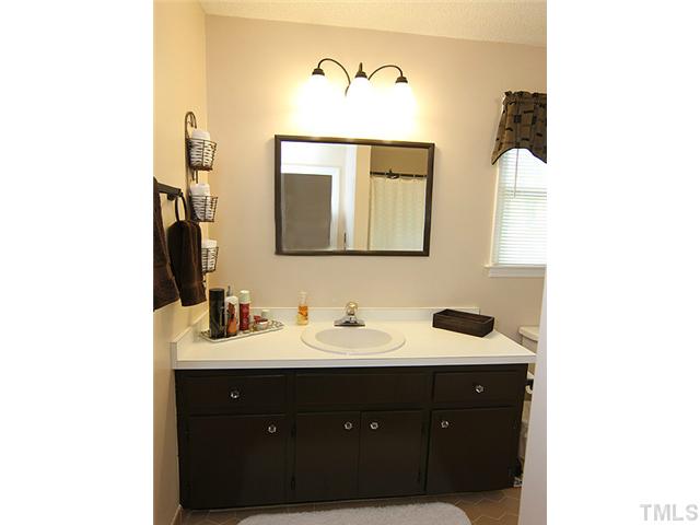 7320 Mill Ridge Road Raleigh, NC 27613 - Photo 17 of 25 a bathroom with a sink and a mirror