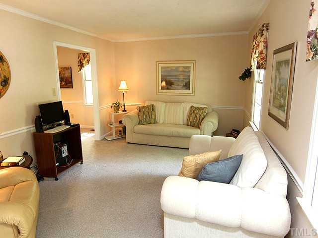 7320 Mill Ridge Road Raleigh, NC 27613 - Photo 5 of 25 a living room with furniture and a flat screen tv