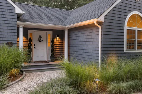 a front view of a house with garden