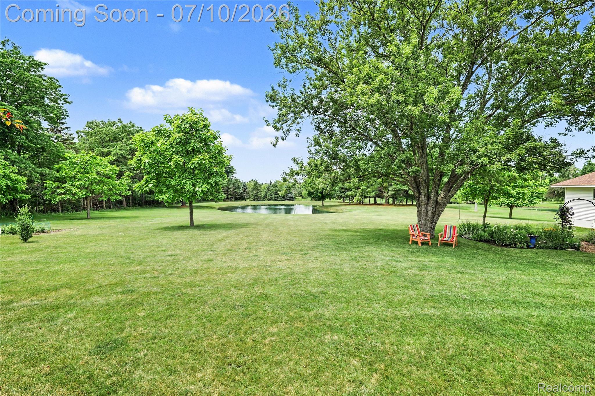 2180 Hurst Road St. Clair, MI 48079 - Photo 30 of 39 Expansive green lawn with mature trees and a visible pond
