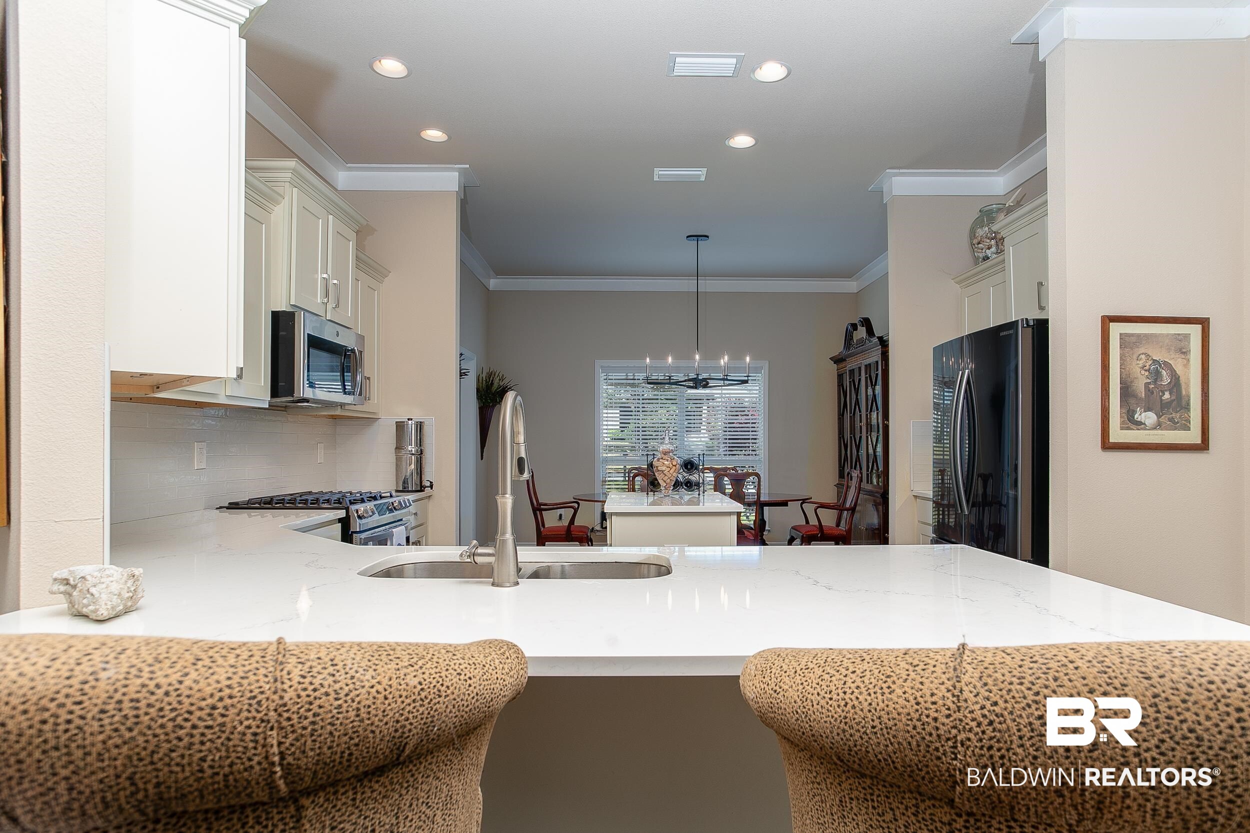 13154 Vincent Court Foley, AL 36535 - Photo 6 of 41 Kitchen featuring decorative backsplash, ornamental molding, stainless steel appliances, a sink, and a notable chandelier