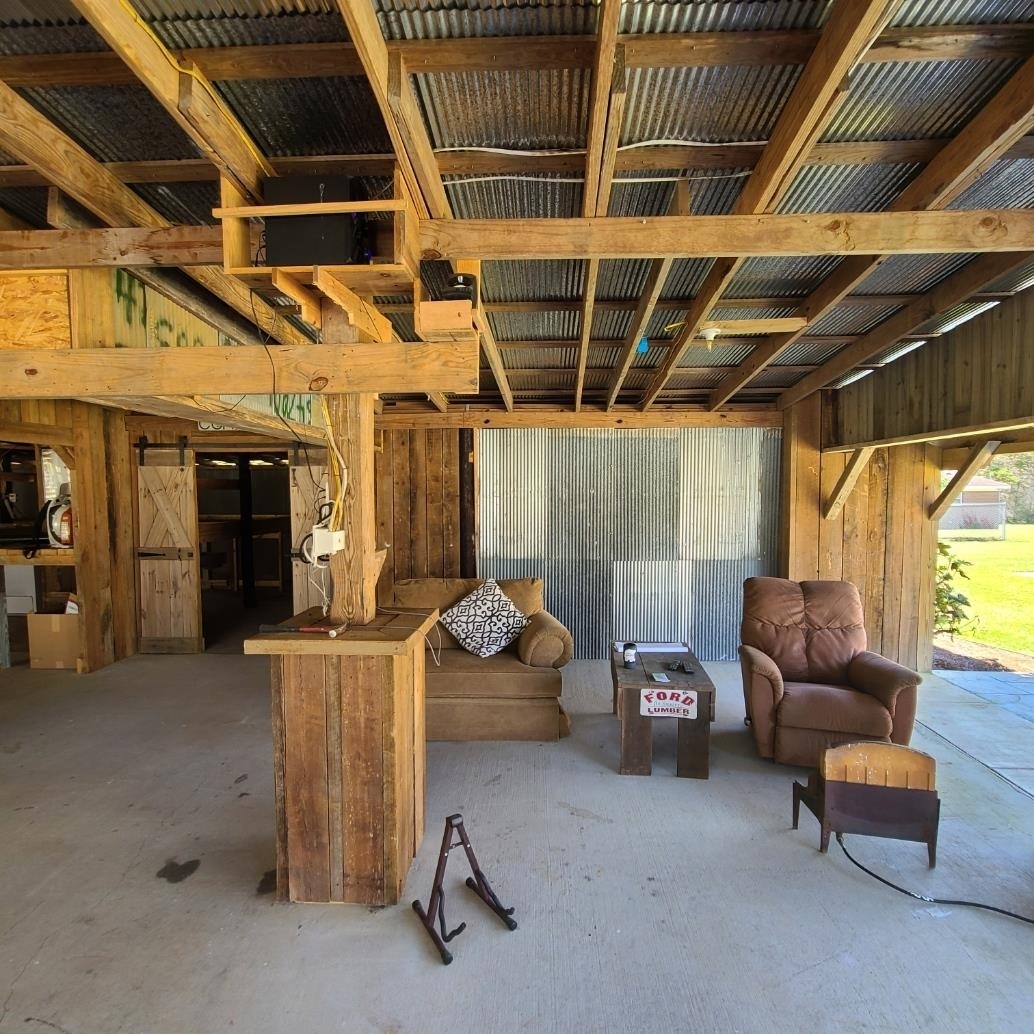 10051 Blackwell Nursery Road Semmes, AL 36575 - Photo 14 of 54 Living room featuring a barn door and wooden walls