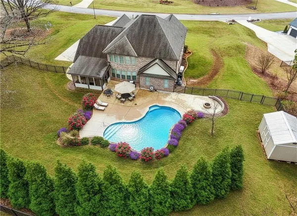 a view of a backyard with swimming pool