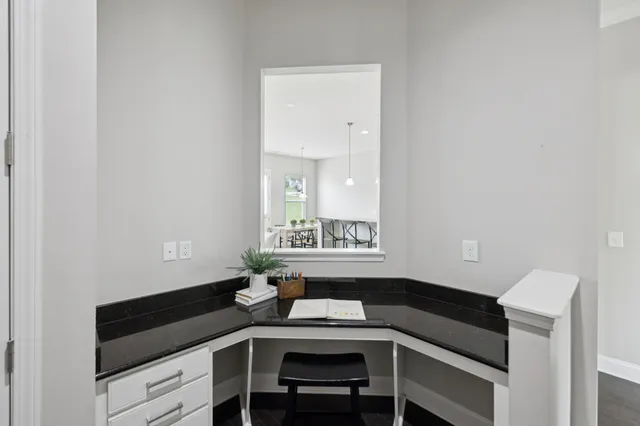 a living room with furniture a fireplace and a large window