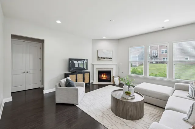 a living room with furniture two window and a fireplace
