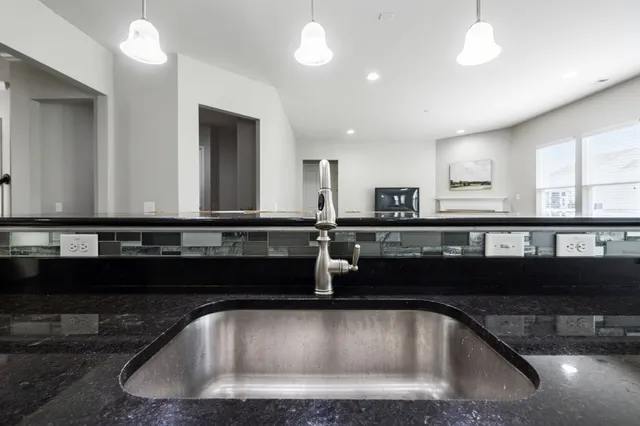 an empty room with a ceiling fan and a window