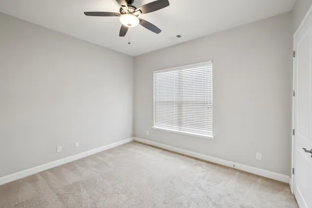a bathroom with a shower curtain and a toilet