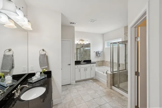 a bedroom with bed and a large window