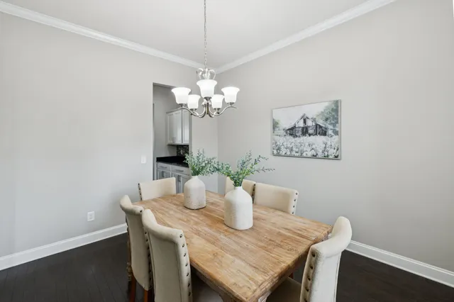 a kitchen with granite countertop a sink a stove and cabinets