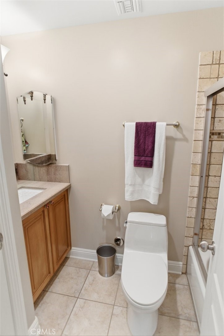 31233 Romero Canyon Road Castaic, CA 91384 - Photo 25 of 38 a bathroom with a granite countertop toilet and a sink