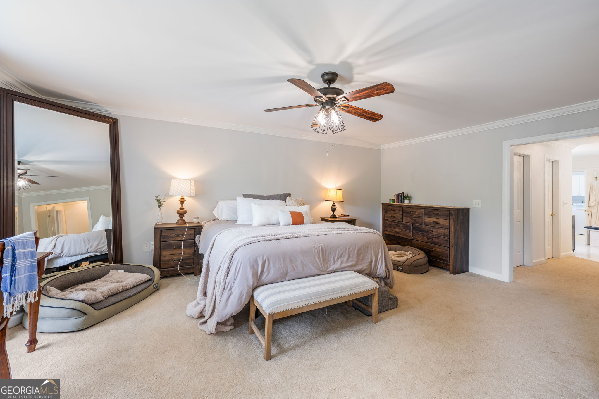 570 Martin Mill Road Moreland, GA 30259 - Photo 21 of 68 a spacious bedroom with a bed and a chandelier