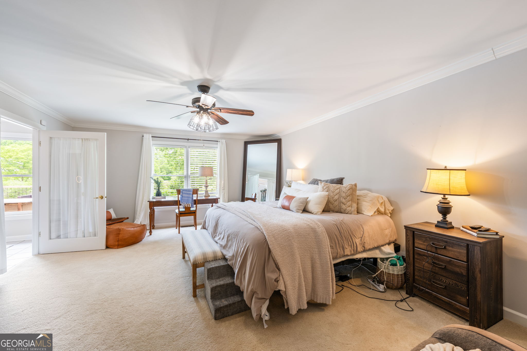 570 Martin Mill Road Moreland, GA 30259 - Photo 22 of 68 a bedroom with a bed and a chandelier