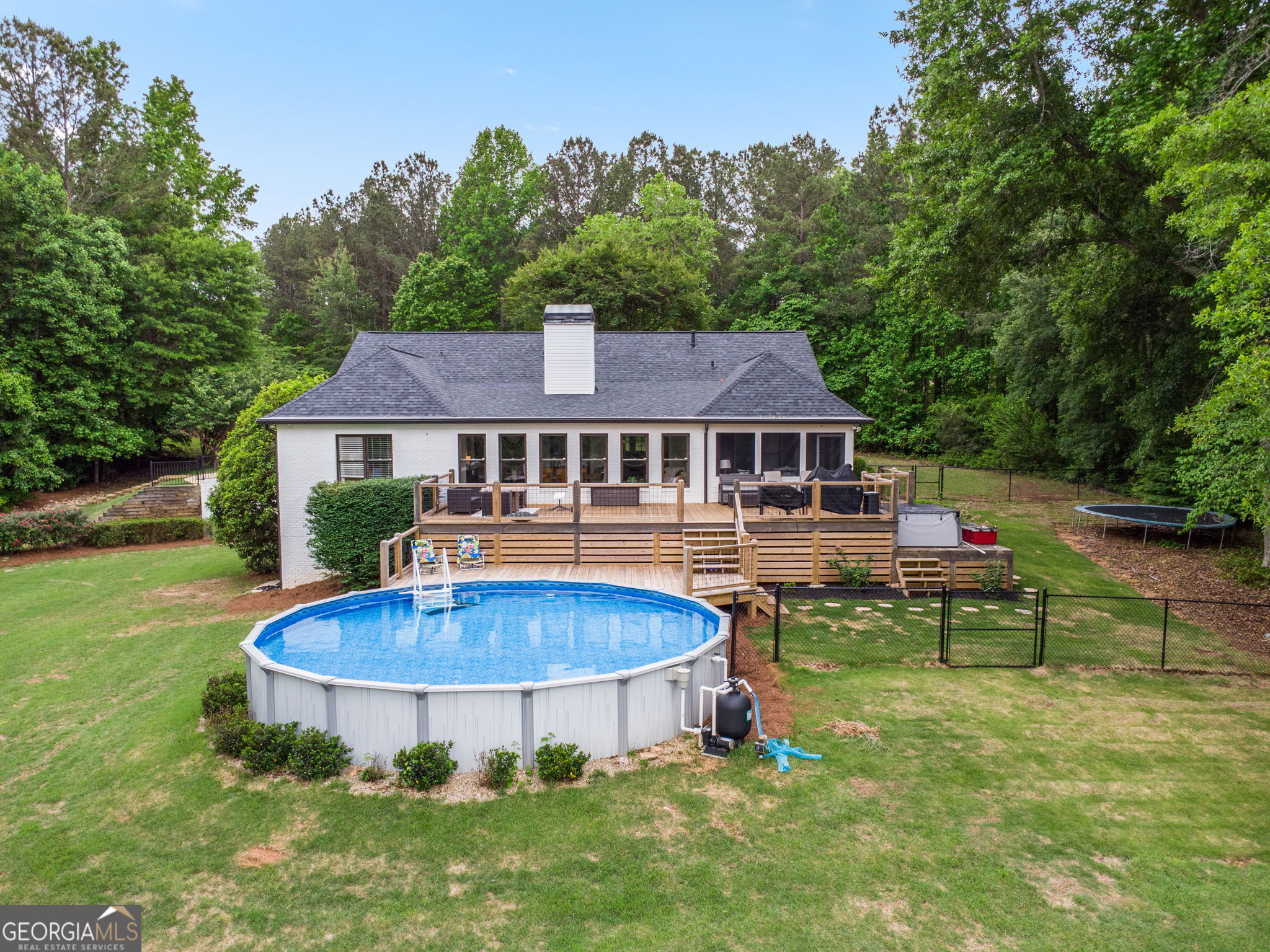 570 Martin Mill Road Moreland, GA 30259 - Photo 59 of 68 a view of a house with a swimming pool and a yard