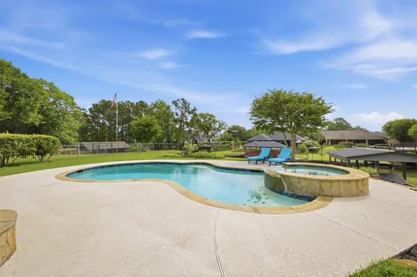 a backyard of a house with table and chairs