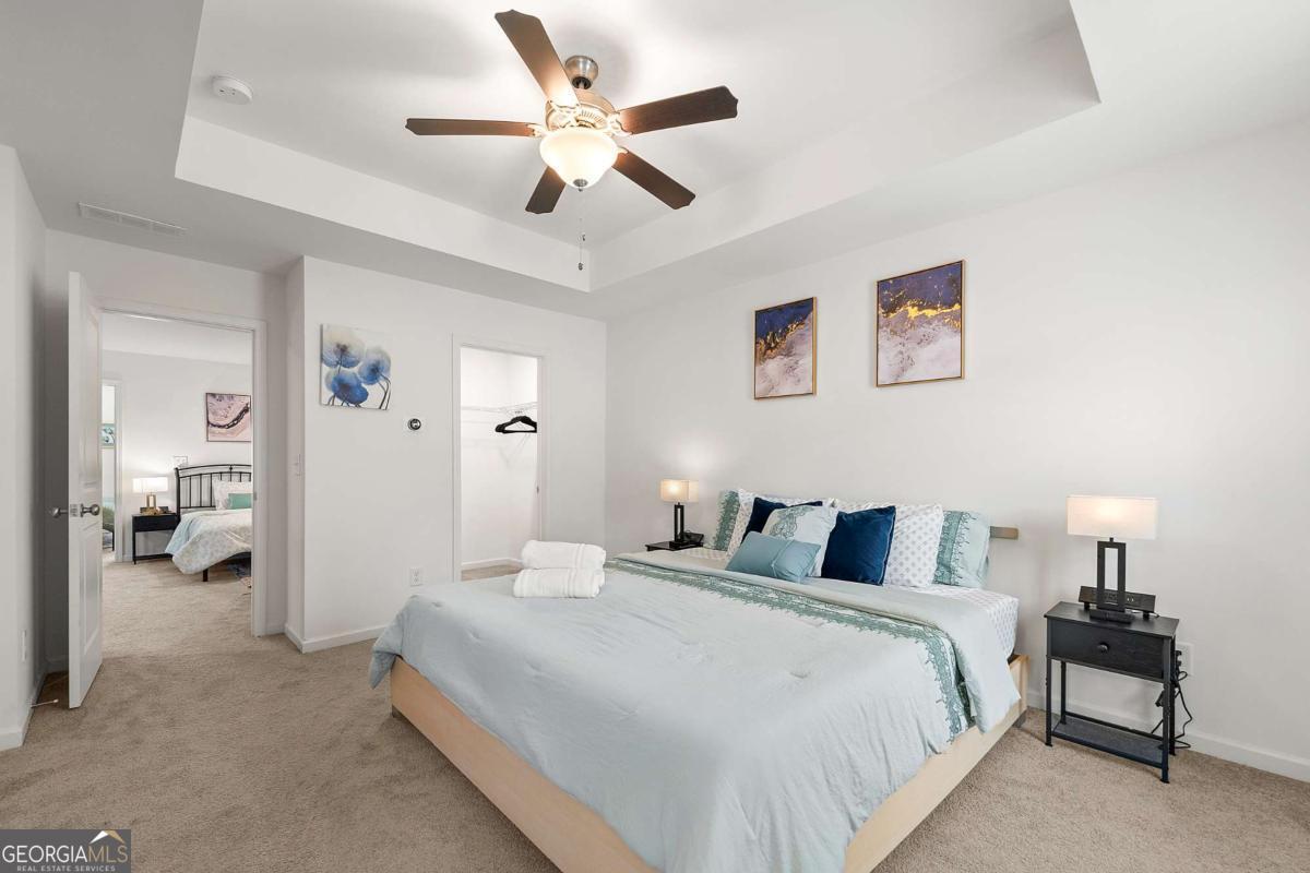 849 Crestwell Circle Atlanta, GA 30331 - Photo 18 of 21 a bedroom with a large bed and a chandelier