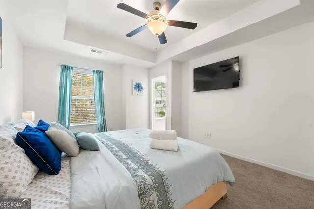 a bedroom with a large bed and a flat screen tv