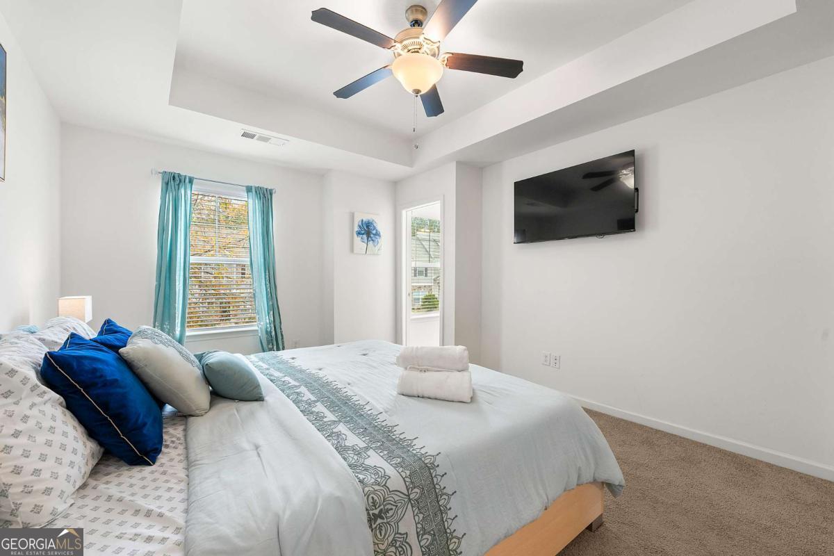 849 Crestwell Circle Atlanta, GA 30331 - Photo 19 of 21 a bedroom with a large bed and a flat screen tv