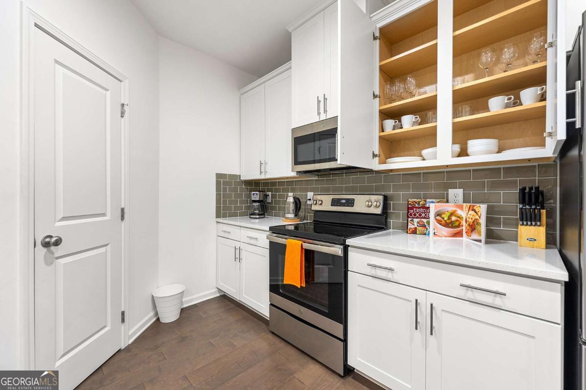 849 Crestwell Circle Atlanta, GA 30331 - Photo 6 of 21 a kitchen with stainless steel appliances granite countertop white cabinets and a stove