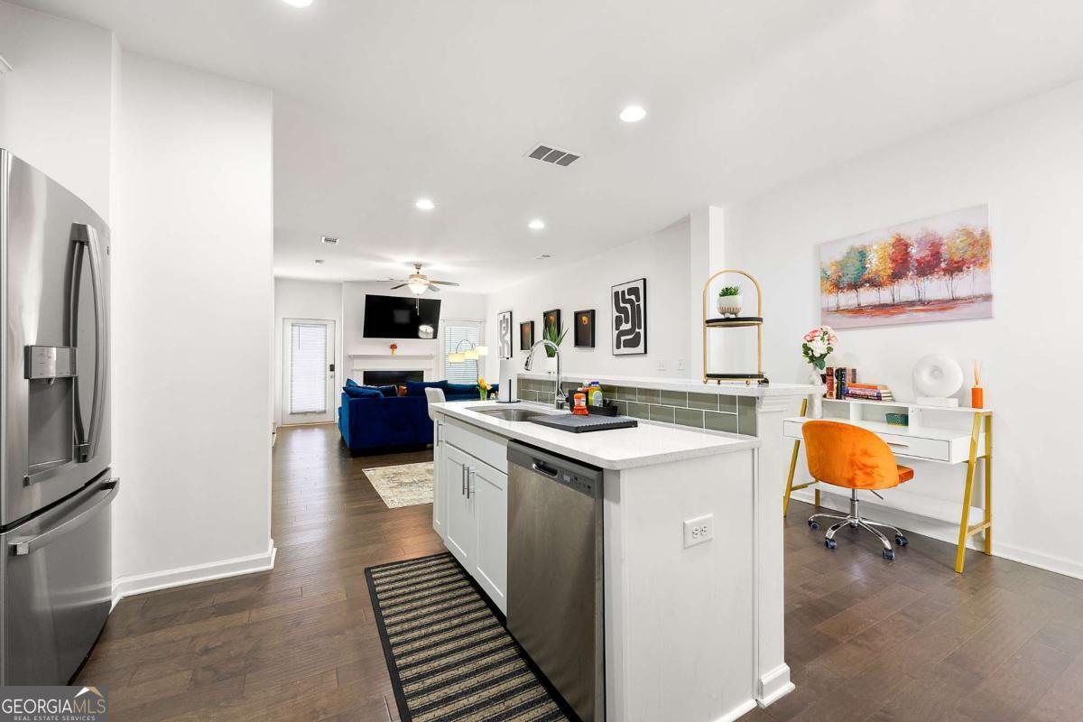 849 Crestwell Circle Atlanta, GA 30331 - Photo 7 of 21 a kitchen with a sink a counter top space stainless steel appliances and cabinets