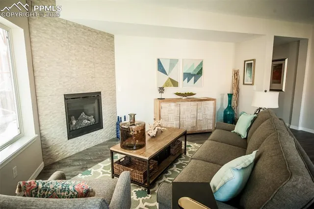 a living room with furniture and a fireplace