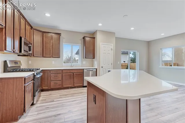 a kitchen with a sink cabinets and wooden floor