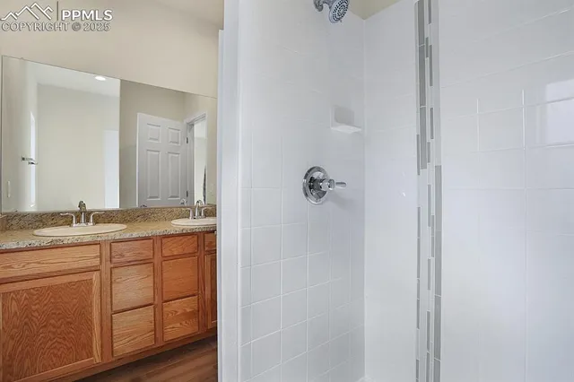 a bathroom with a granite countertop sink and a mirror
