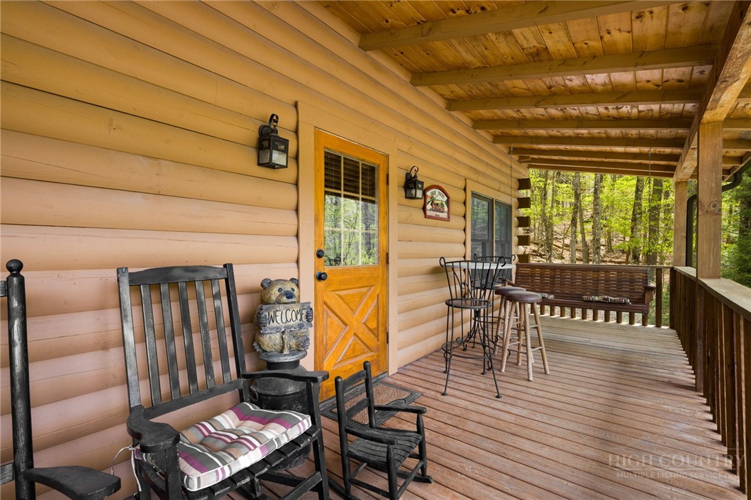 259 Greenbriar Road Beech Mountain, NC 28604 - Photo 6 of 41 a balcony with chairs and wooden floor