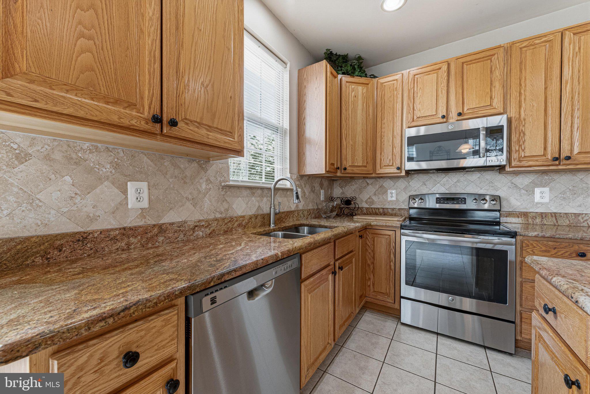 602 Shanks Evans Road Northeast Leesburg, VA 20176 - Photo 13 of 43 Modern kitchen with warm wood tones.