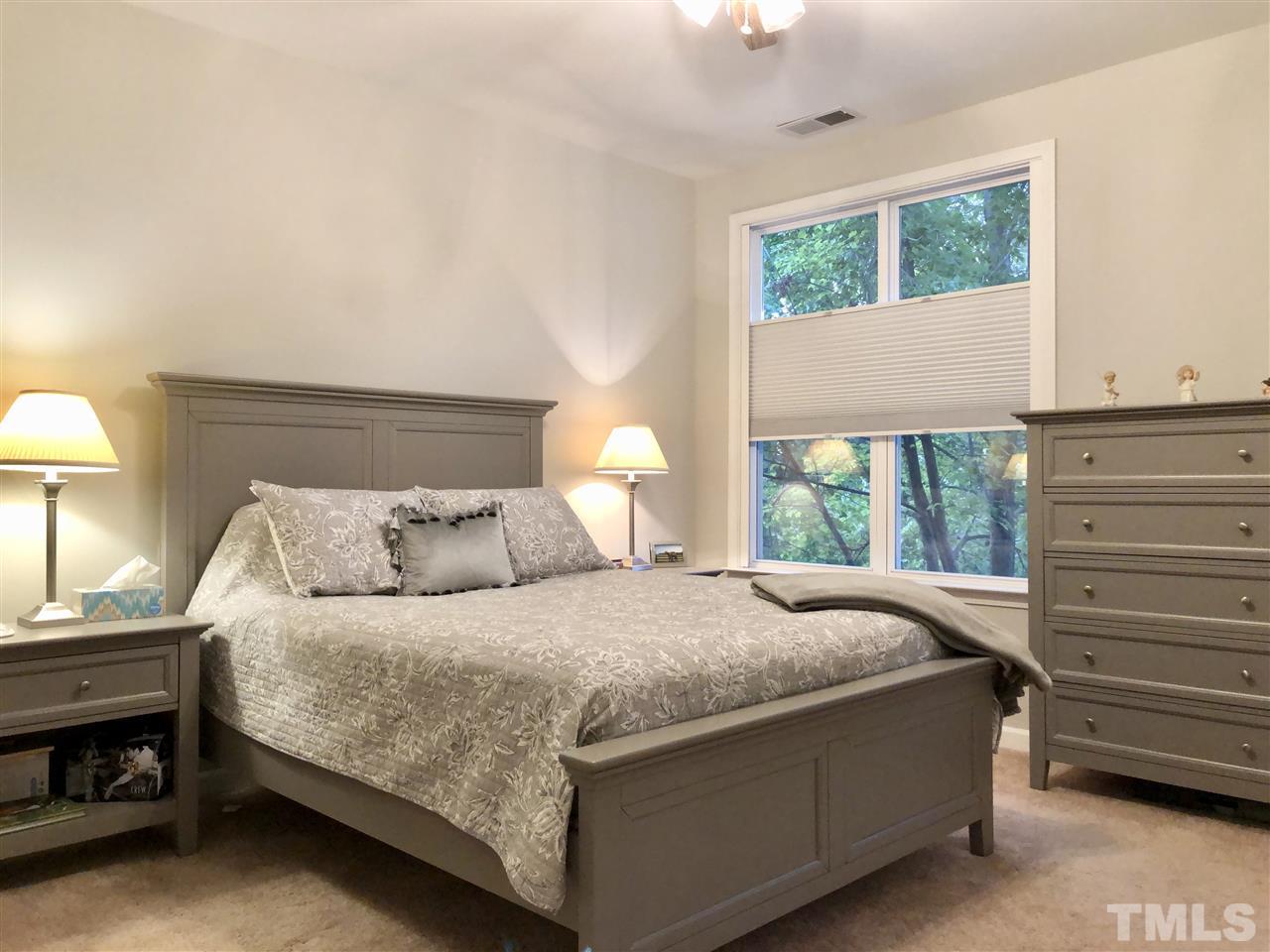 212 West Savannah Ridge Road, Unit 212 Holly Springs, NC 27540 - Photo 12 of 21 a bedroom with a bed and a window