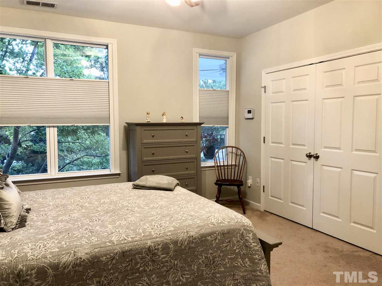 212 West Savannah Ridge Road, Unit 212 Holly Springs, NC 27540 - Photo 13 of 21 a bedroom with a bed and a window