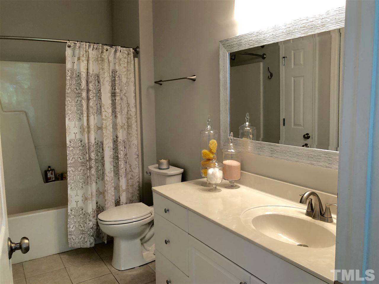 212 West Savannah Ridge Road, Unit 212 Holly Springs, NC 27540 - Photo 15 of 21 a bathroom with a sink toilet and shower