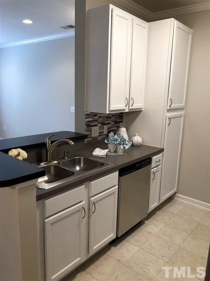 212 West Savannah Ridge Road, Unit 212 Holly Springs, NC 27540 - Photo 5 of 21 a close view of sink and cabinets