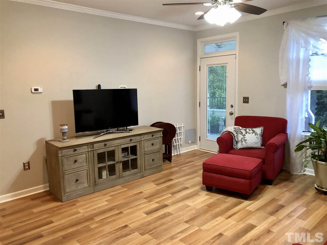 212 West Savannah Ridge Road, Unit 212 Holly Springs, NC 27540 - Photo 8 of 21 a living room with furniture and a flat screen tv