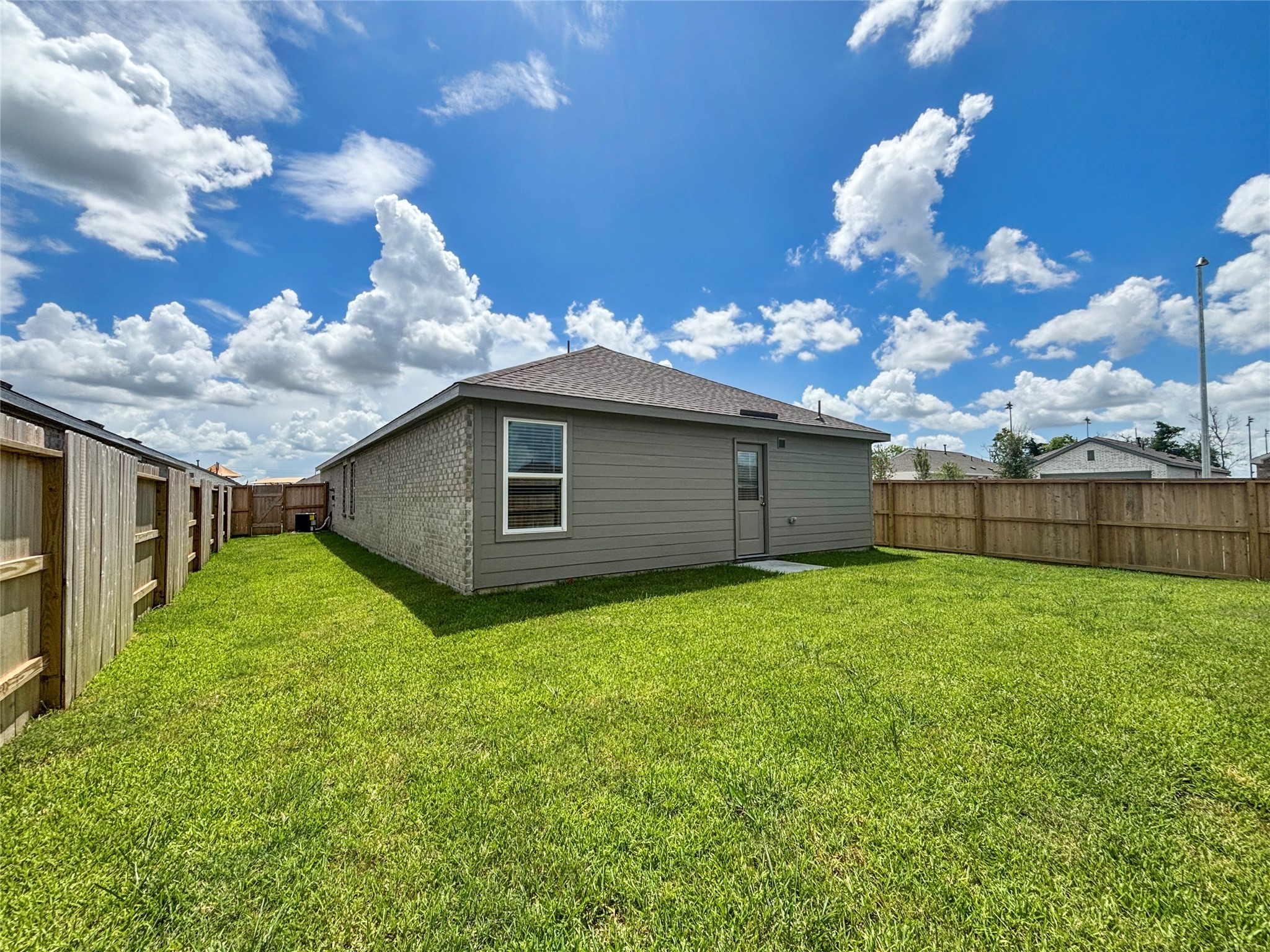 6022 Standpiper Loop Baytown, TX 77521 - Photo 15 of 16 a backyard of a house with lots of green space
