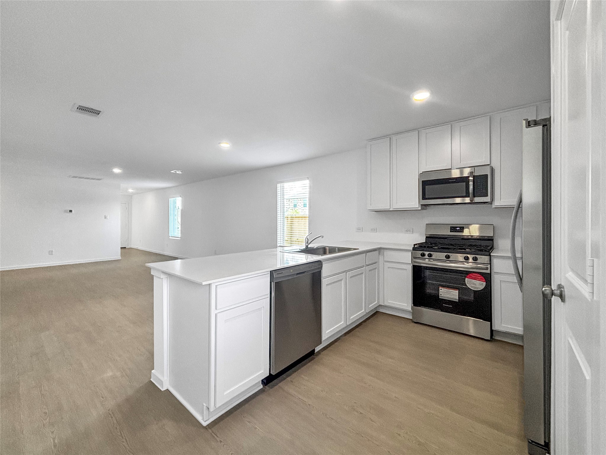 6022 Standpiper Loop Baytown, TX 77521 - Photo 3 of 16 a kitchen with cabinets and a stove top oven